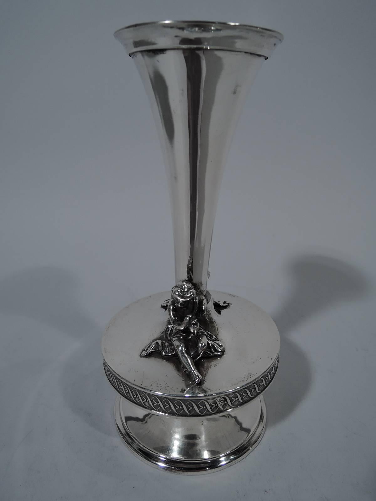 Classical coin silver vase. Made by Gorham in Providence, circa 1860. Conical with raised and spread foot. Bellied “platform” has two cast figures of seated and adroitly draped cherubs. Rinceaux band. Hallmark includes no. 610. Weight: 9.6 troy