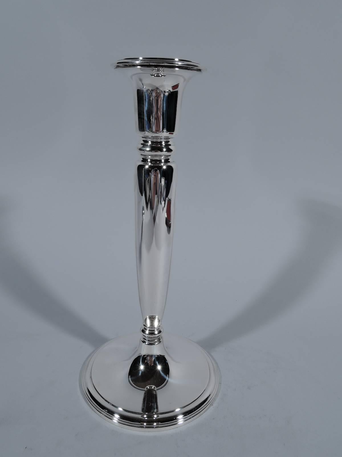 Pair of Modern sterling silver candlesticks. Made by Tiffany & Co. in New York, circa 1926. Each: Tapering shaft terminating in knop on raised foot. Shaft top has knop surmounted by urn socket with stepped rim. Hallmarks includes pattern no. 20762