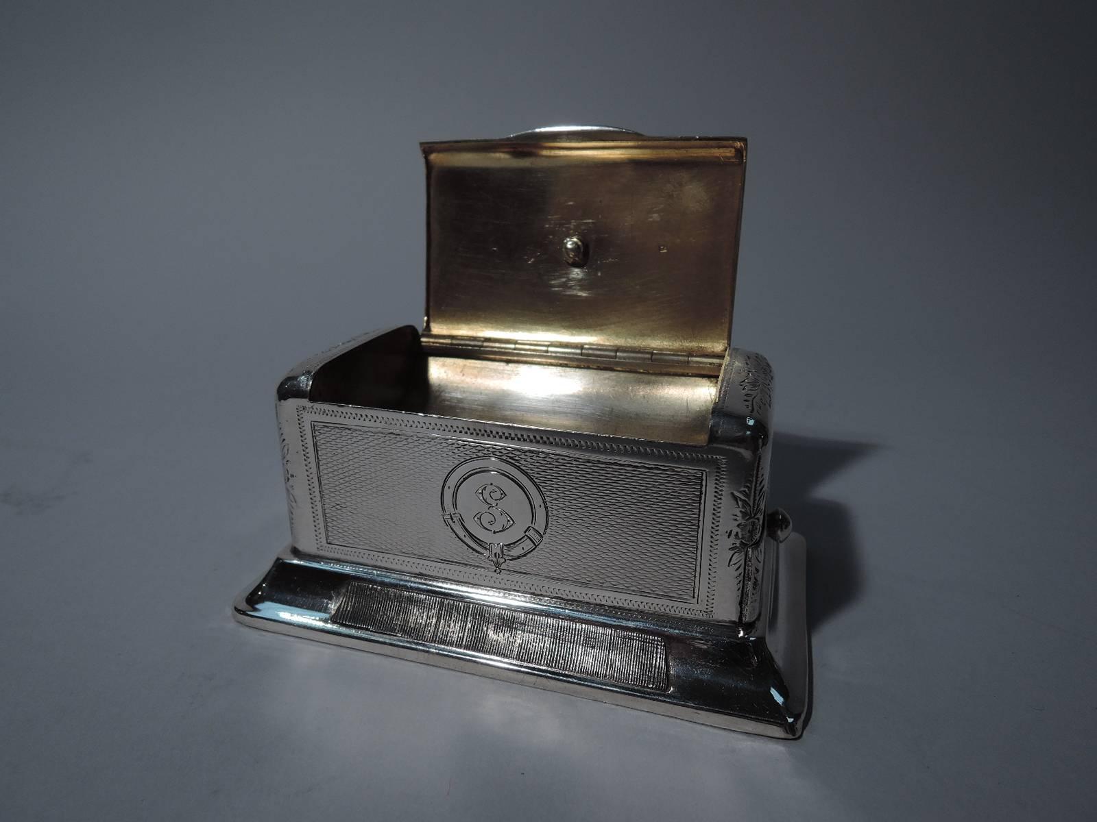 Austrian 800 silver matchbox, circa 1880. Rectangular with engine-turned panels and engraved foliage and flowers. Cover hinged and tabbed with fox finial. End drawer with ball finial. Spread foot with strike. Box and cover interior lightly gilt as
