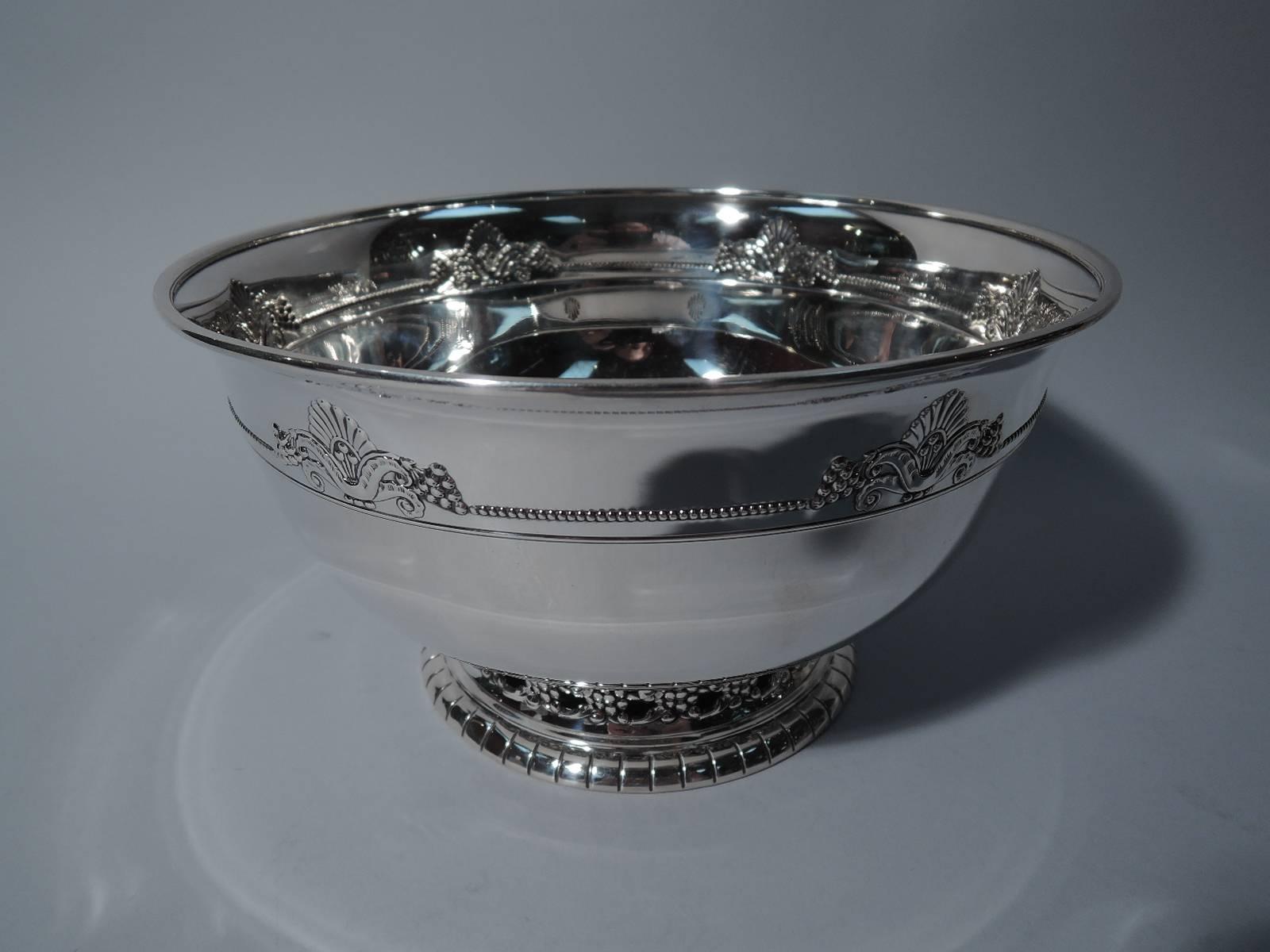 A very interesting Art Deco sterling silver bowl in Nordic pattern. Made by Wallace in Wallingford, circa 1930. Curved sides and flared rim. Ornament comprising stylized leaf supported by volute scrolls and bordered by grape bunches joined by
