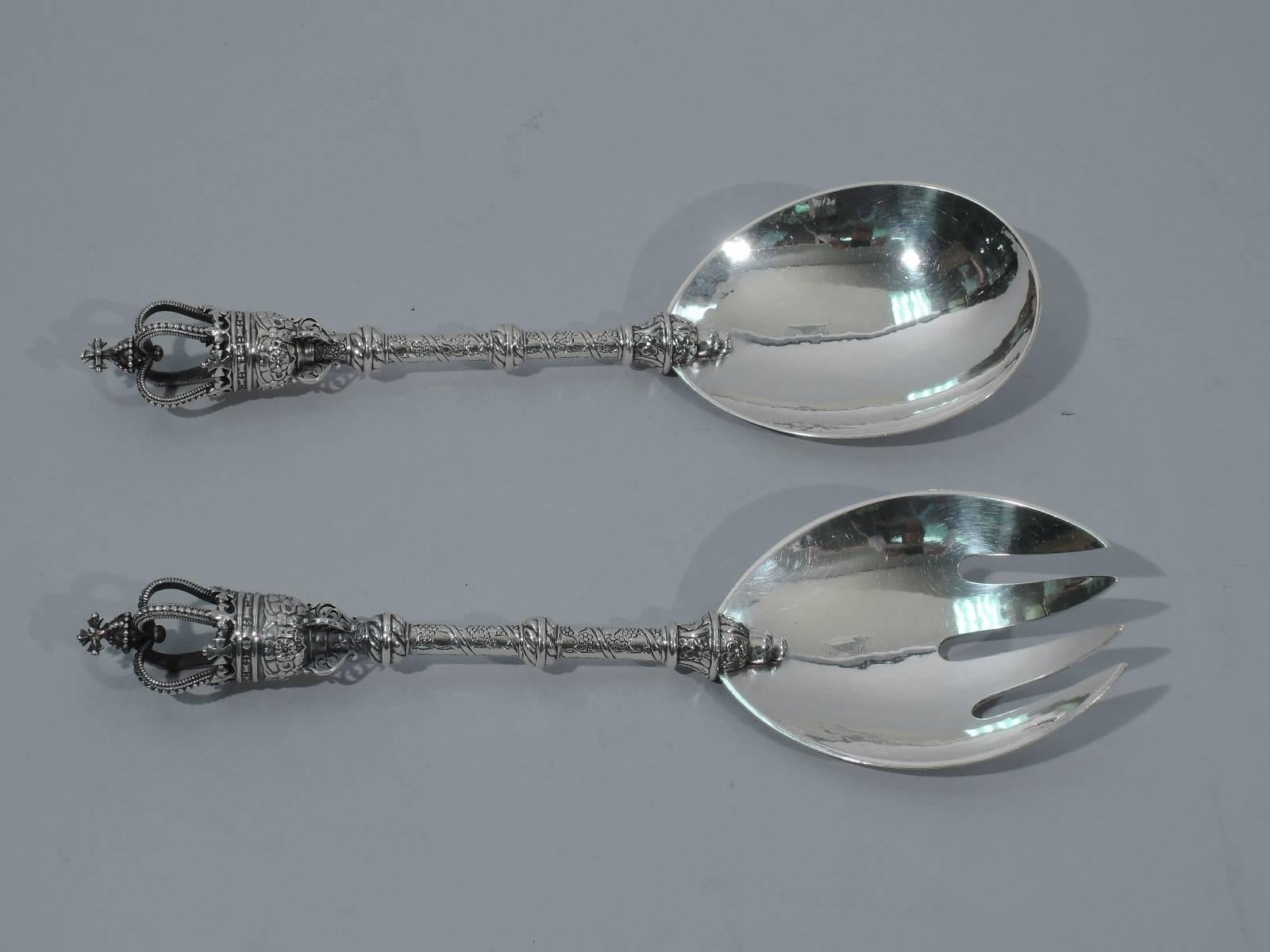 Early sterling silver salad serving pair. Made by Georg Jensen in Copenhagen, circa 1927. This pair comprises spoon and fork. Each: regal crown terminal, knopped and incised stem, and curved hand-hammered bowl (fork has 4 tines). A rare foray into