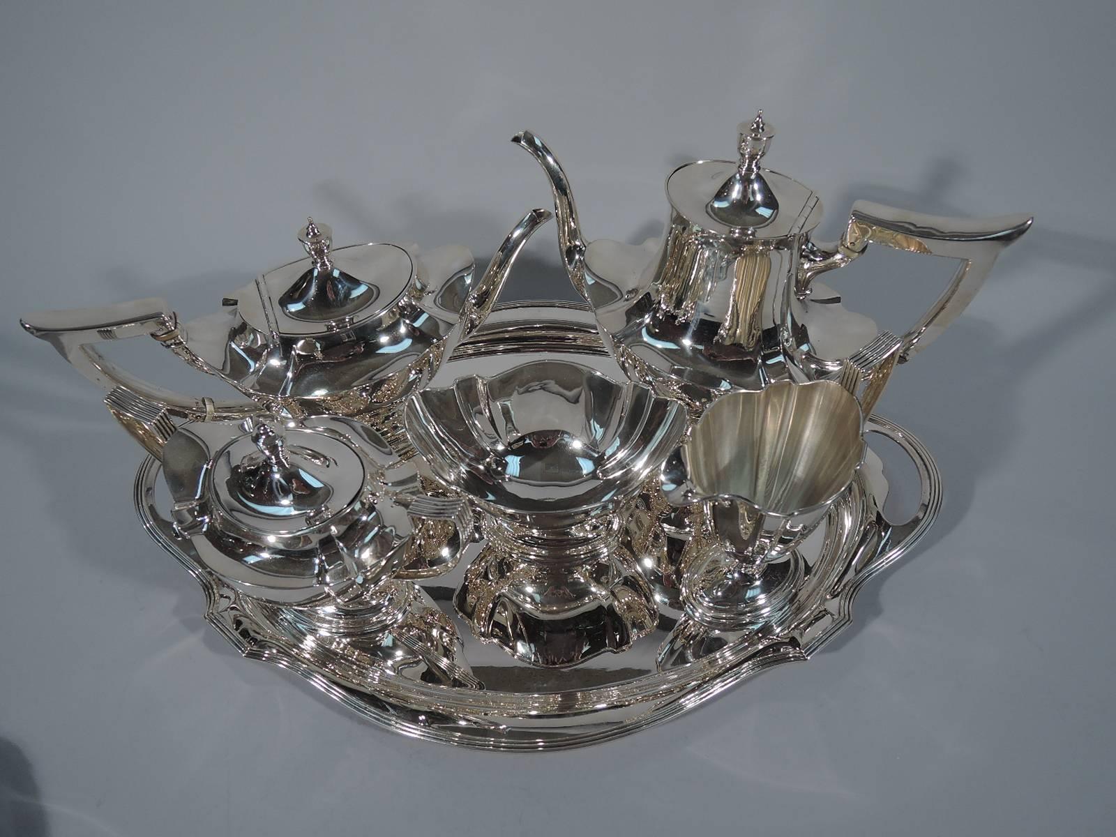 Sterling silver tea and coffee set in Plymouth pattern. Made by Gorham in Providence in 1919. This set comprises teapot, coffeepot, creamer, sugar and waste bowl on tray.

Each: curved and paneled body, stepped oval foot, reeded rim, scroll