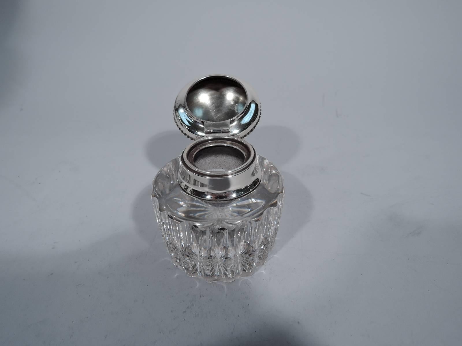 Classical sterling silver inkwell. Made by Gorham in Providence in 1894. Clear glass with fluted sides and ovoid well. Short neck with silver collar and hinged and beaded bun cover. A neat desk accessory. Hallmark includes date symbol and no. S8130.