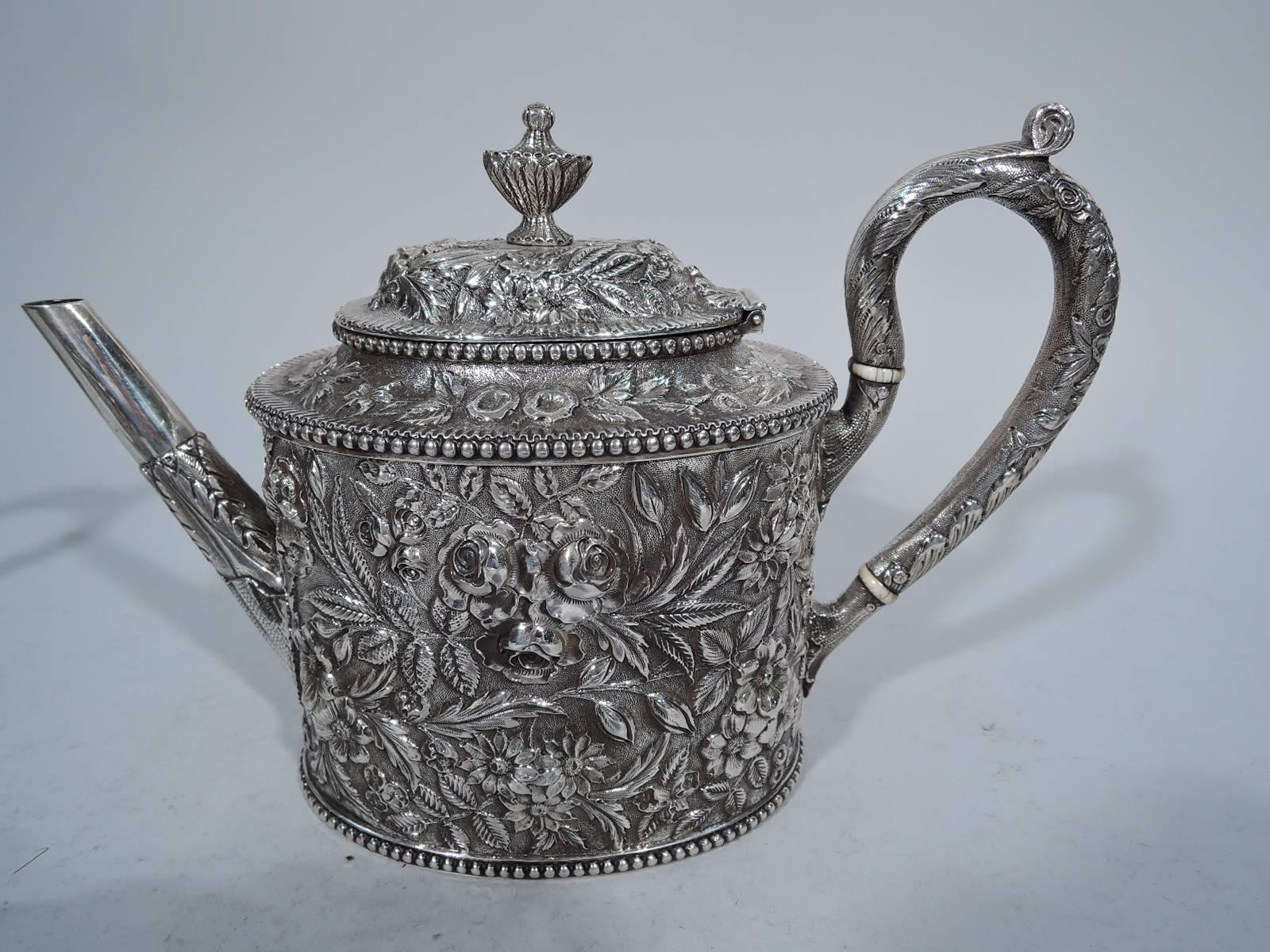Sterling silver tea set. Made by Jacobi & Jenkins in Baltimore, circa 1900. This set comprises coffeepot with hinged cover, teapot with hinged cover, creamer, and sugar with cover.

Each: Ovoid body. All covers domed with vase finial. All handles