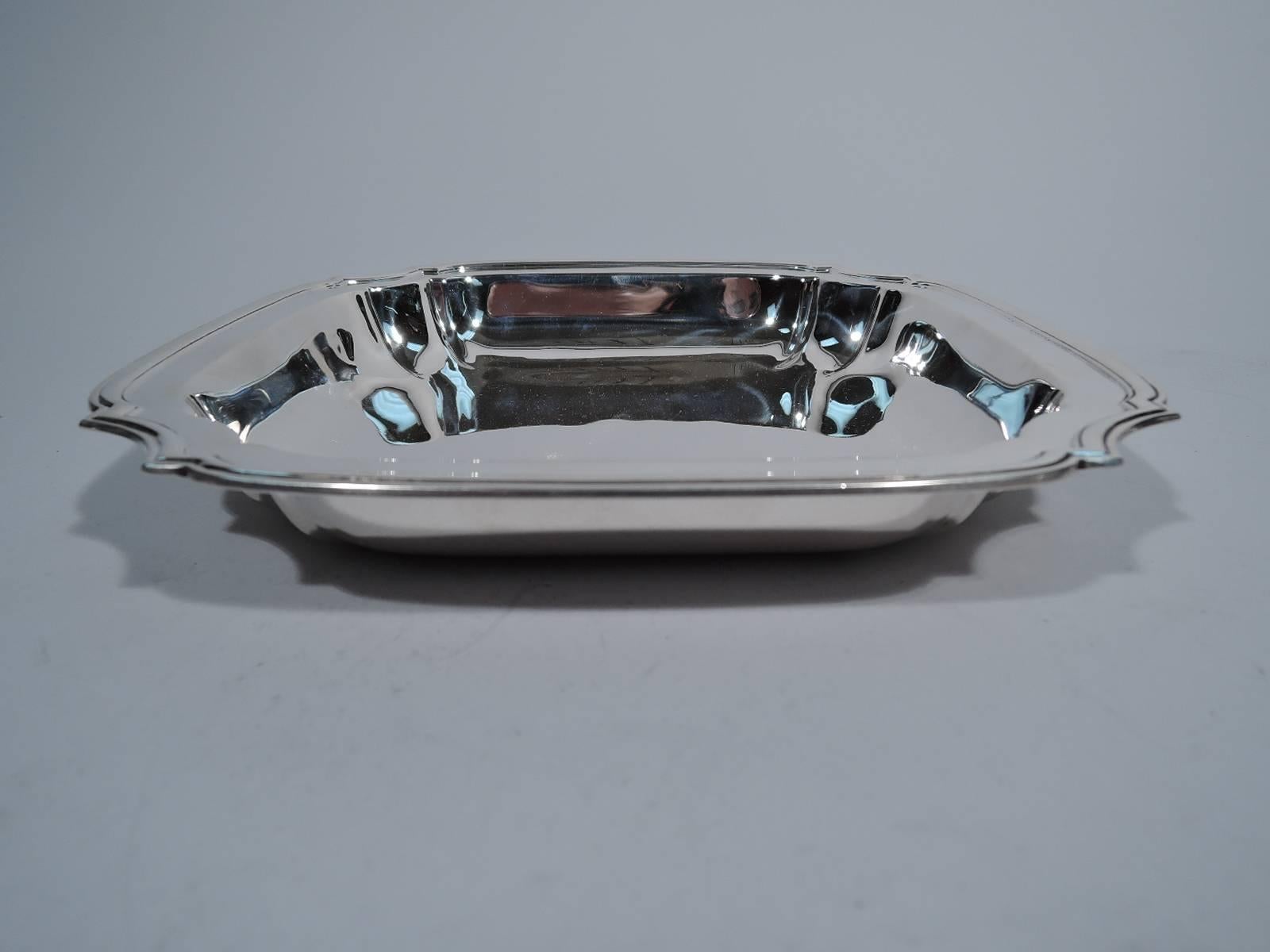 Modern sterling silver bowl. Made by Tiffany & Co. in New York, circa 1922. Squarish with curved and molded sides and concave corners. Hallmark includes pattern no. 20051 (first produced in 1922) and director’s letter m (1907-1947). Very good