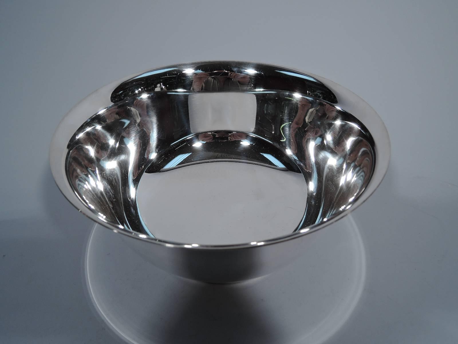 Sterling silver revere bowl. Made by Fisher in Jersey City. The historic form with curved sides, flared rim and stepped foot. Hallmark includes no. 238 and phrase Paul Revere 1768 Reproduction. Very good condition.

Dimensions: H 4 x D 8 1/8 in.