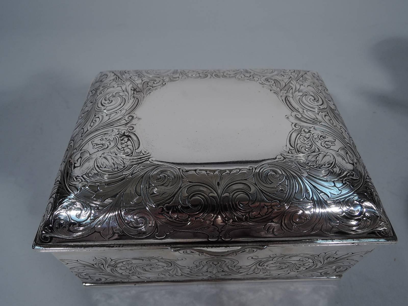 Sterling silver jewelry box. Made by Gorham in Providence, circa 1890, for Shreve, Crump & Low. Rectangular with straight sides. Cover hinged and curved with scrolled tab. Acid-etched foliage and gryphons. A fluid fantasy pattern. Cover top has