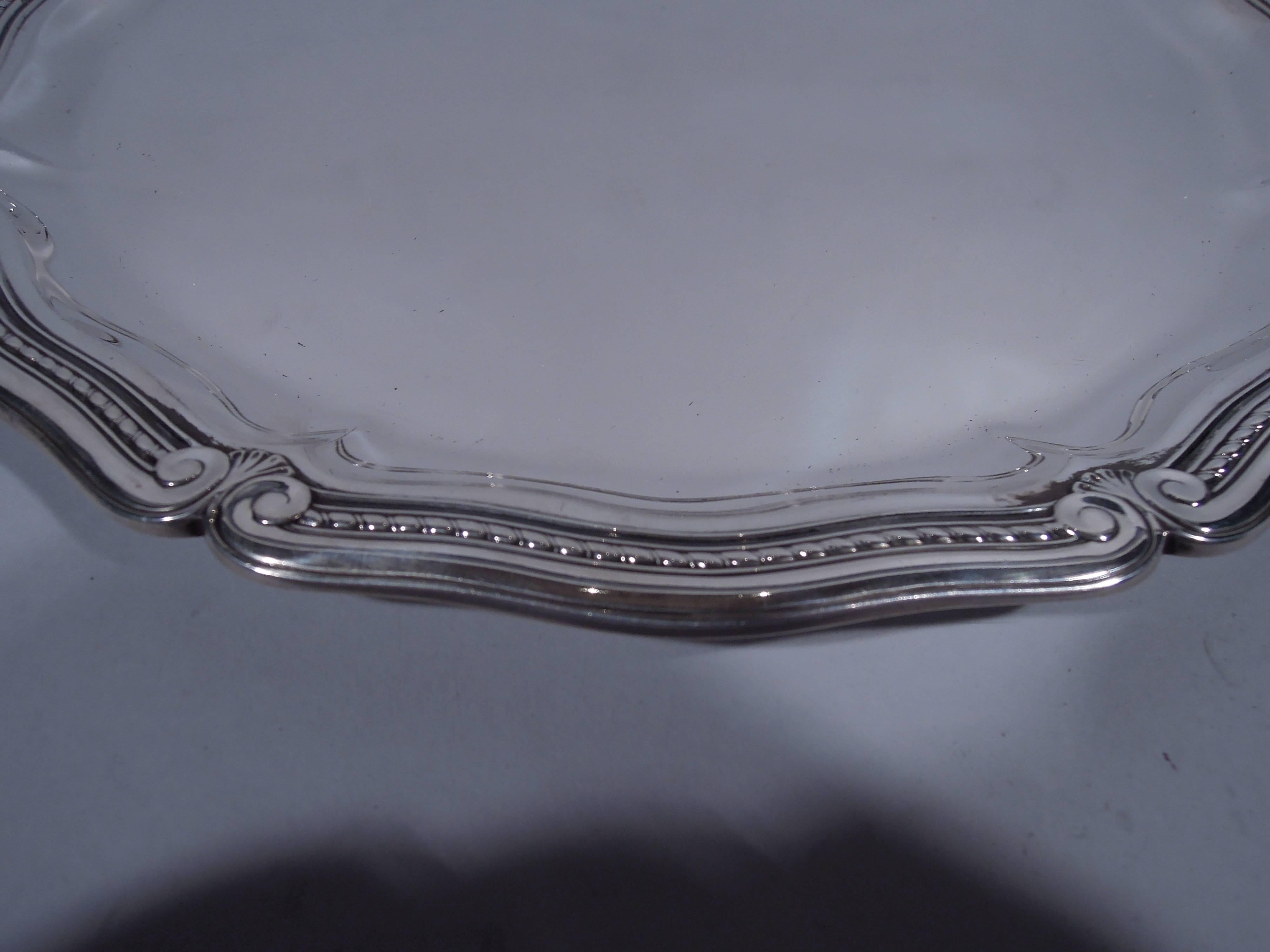 Sterling silver tray. Made by Tiffany & Co. in New York, circa 1911. Scrolled well bordered by flat scrolls with volute terminals, gadrooning and foliage. Classical motifs updated for modern tastes. The pattern (no. 18061) was first produced in