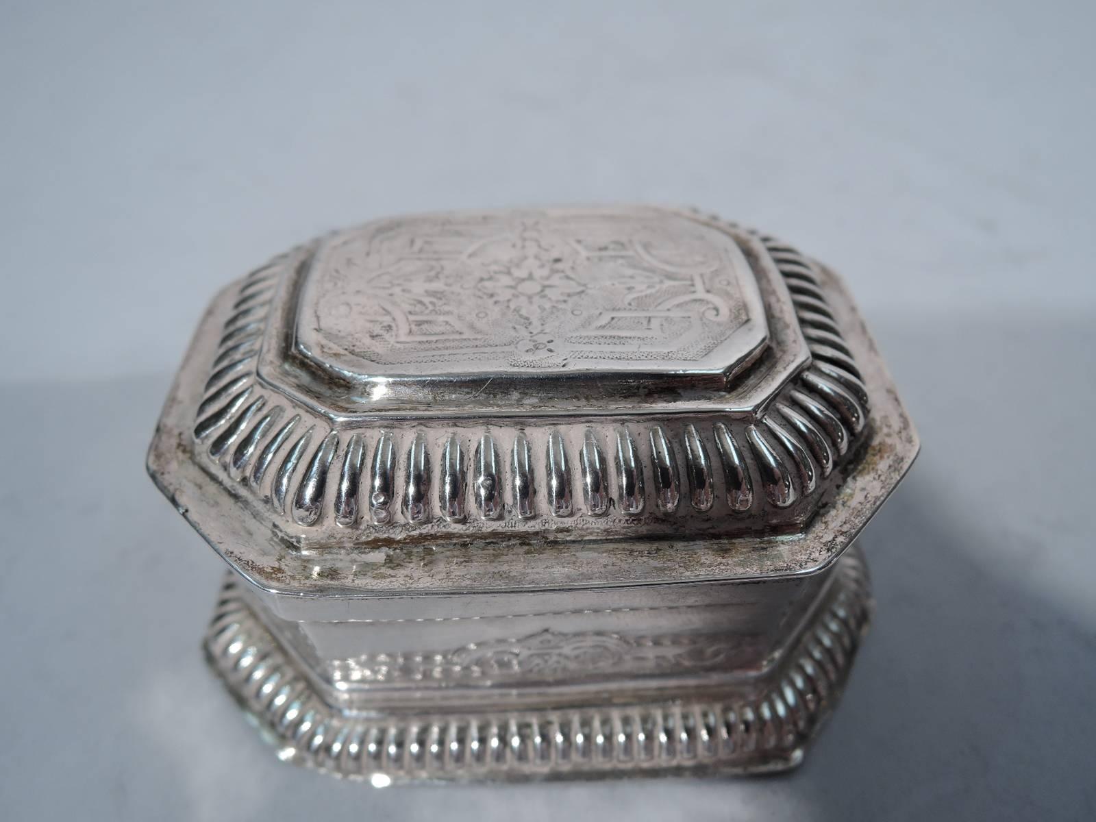 Silver spice box. Made by Johann Leonhard Eyssler in Nuremberg in early 18th century. Rectangular with chamfered corners and spread foot. Cover hinged and stepped. Gadrooning and chased strap work. Interior partitioned. Fully hallmarked on