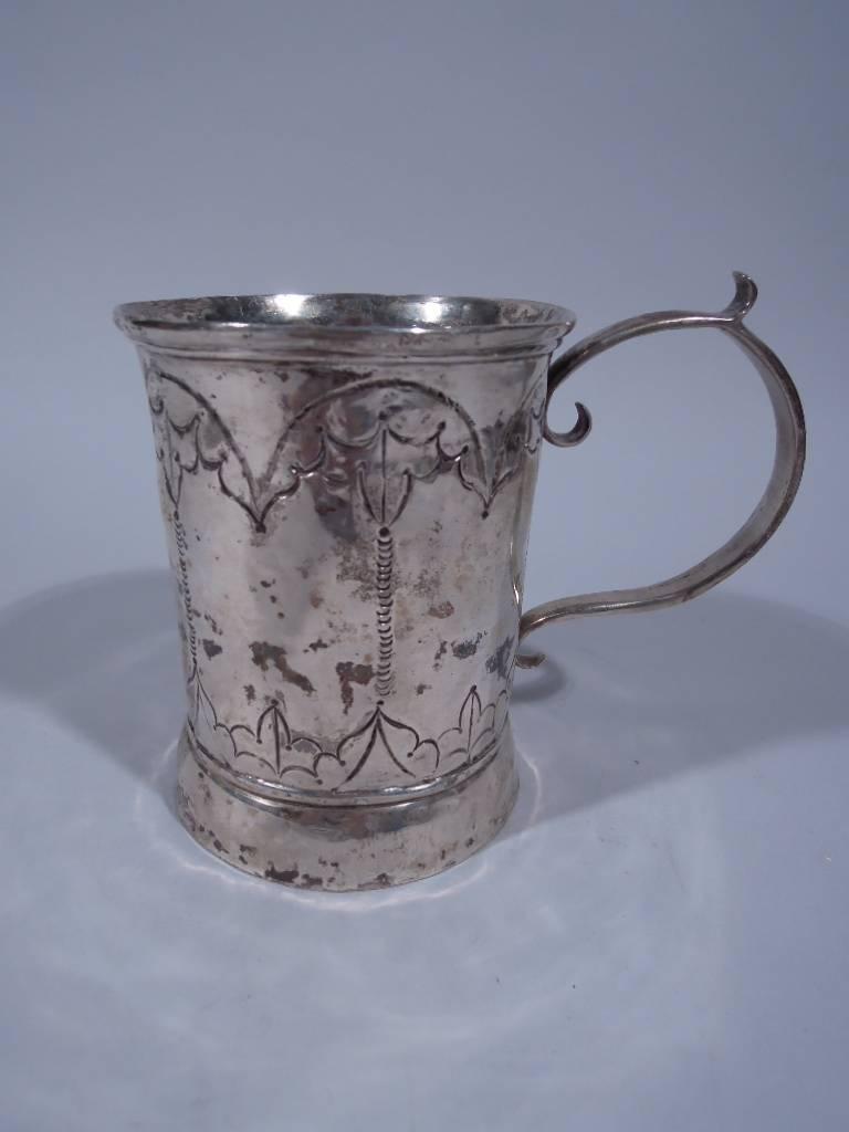 South American silver mug with all-over decoration, circa 1840. Handmade. Solid capped curved handle. Arcade with stylized leaf decoration on body. Heavy weight: 15.62 troy ounces.  