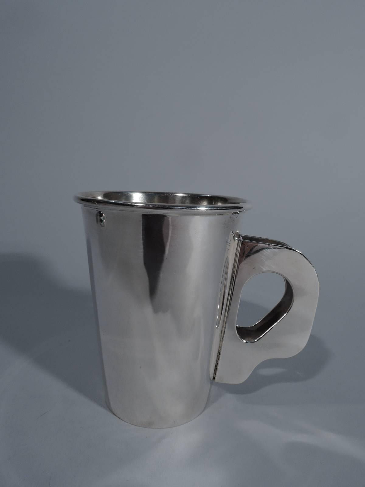 Sterling silver mug. Made by Bulgari in Italy. Straight and tapering sides, molded rim, and double handle with cut-out oval finger rest. Interior has light gilt wash. Perfect for morning coffee. Also makes a great baby cup for one super hip,