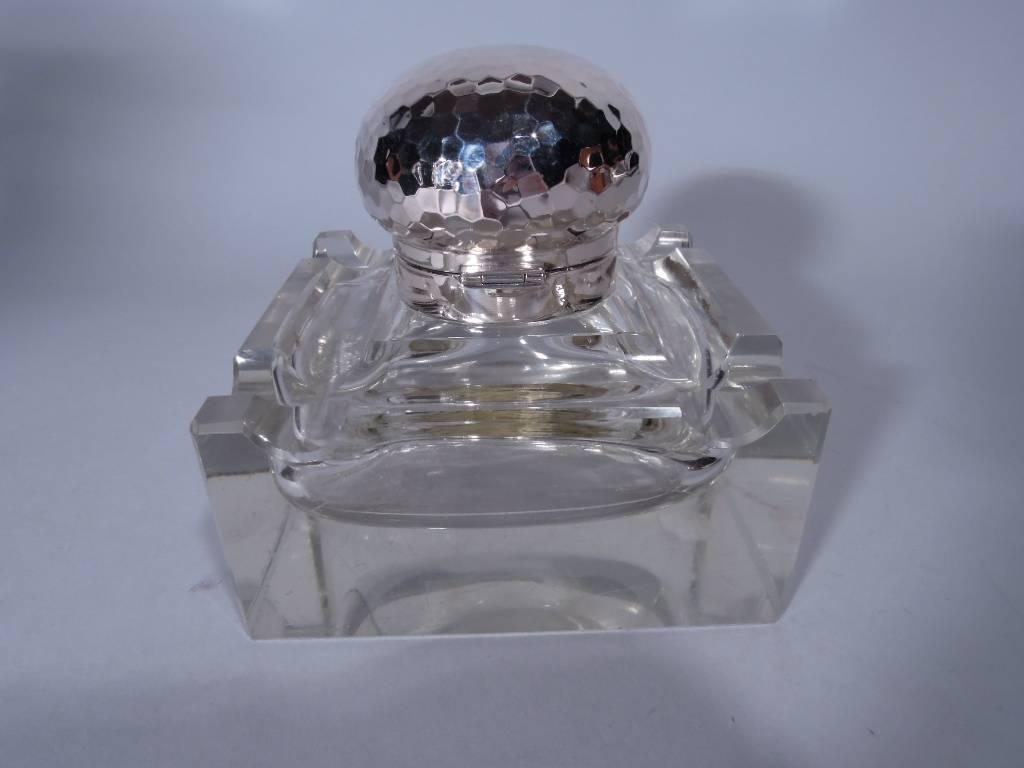 Cut-glass and 826 silver inkwell. Made by Christian F. Heise in Denmark in 1910. Rectangular clear glass base with cut pen rest on each side. Short neck with silver collar and hinged cover. Cover has faceted hand hammering reminiscent of a 1970s