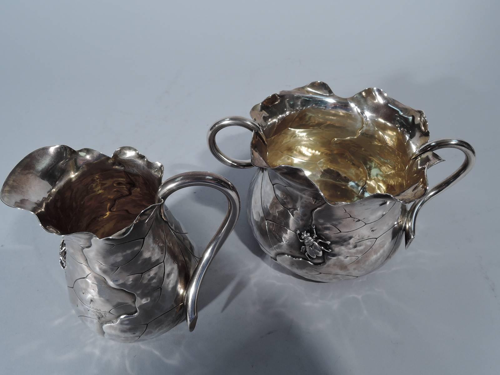 Japonesque applied sterling silver creamer and sugar. Made by Shiebler in New York, circa 1890. Both: wraparound leaf with engraved veins and wavy ruffled rim that evokes the wispy fragility and irregularities of a real leaf. Applied bugs and