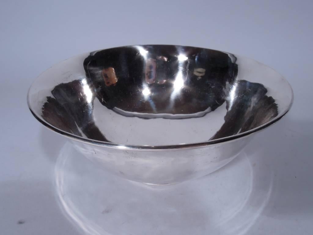 Handmade sterling silver bowl. Made by Stone Associates in Gardner, Mass. Curved sides, molded rim, and stepped foot. Hallmark (circa 1938-1957) includes craftsman’s initial C. Very good condition and patina.

Dimensions: H 3 1/4 x D 7 1/4 in.