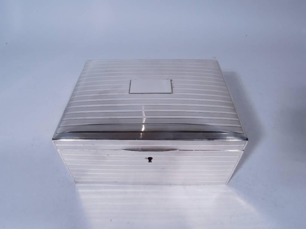 Edwardian sterling silver jewelry box. Made by John Chatellier, circa 1915, for Tiffany & Co. in New York. Box has straight sides. Cover curved and hinged with tapering tab and central rectangular tablet (vacant) applied to center. Box has