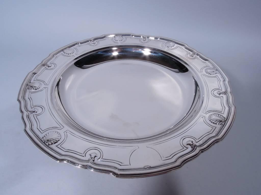 Modern classical sterling silver compote. Made by Tiffany & Co. in New York, circa 1911. Shallow well with curved and scrolled rim. Rim has applied alternating scallop shells and trefoils in engraved curvilinear frames. Short concave stem and