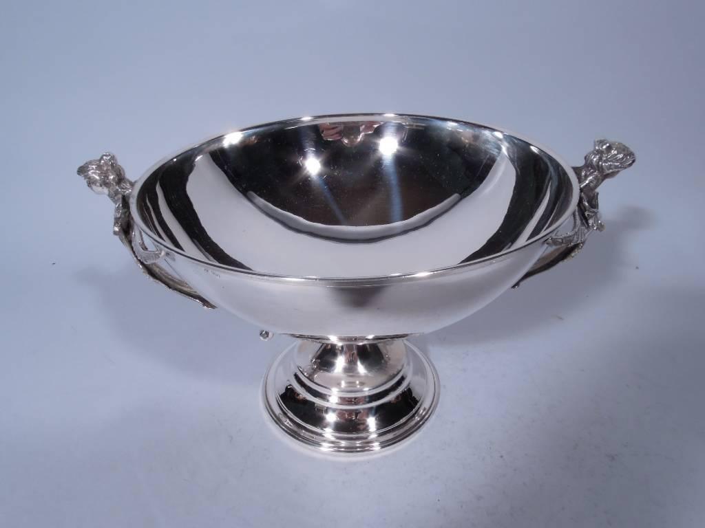 European 900 silver centerpiece bowl. Bowl has curved sides and is mounted to short support on stepped foot. Scrolled side handles with cast female heads and wing mounts. The women are in the temptress mold with long loosely upswept tresses.