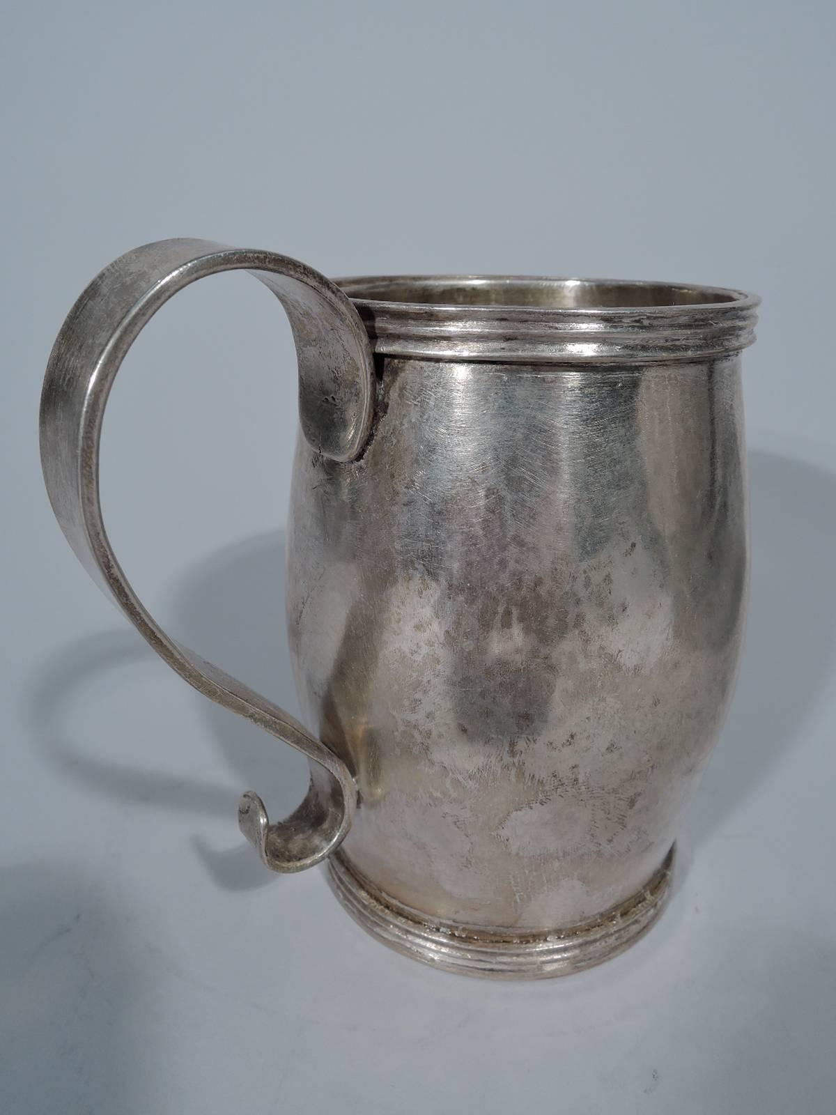 Antique South American silver mug, circa 1850. Barrel form body with reeded rims and fancy scroll handle. Handmade and hand-hammered. Condition: Excellent with wonderful old patina.

Dimensions: H 5 x W 5 1/8 x D 3 3/8 in. Heavy weight: 14.2 troy
