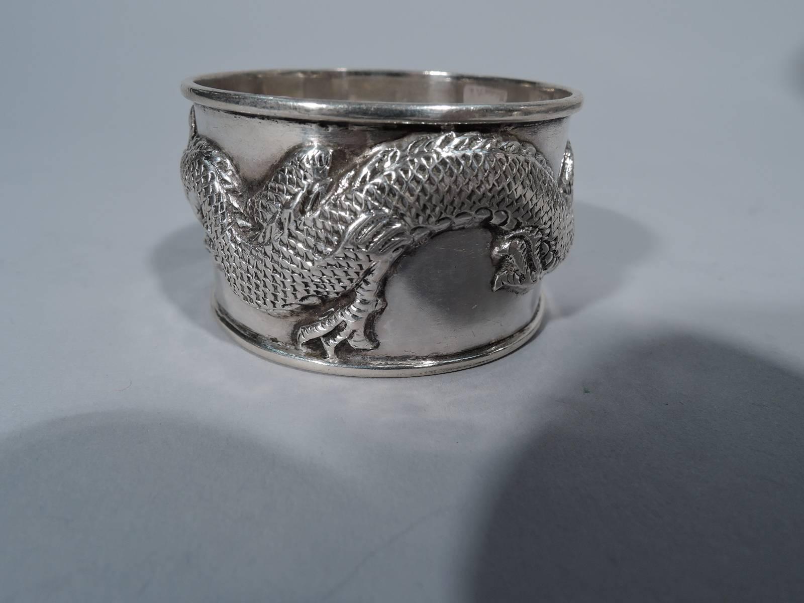 Chinese export silver napkin ring with applied wraparound dragon a scaly, slithering beast. Room for engraving between the snout and tail. Hallmarked Wang Hing, a Hong Kong maker active at the turn of the century. Excellent quality and