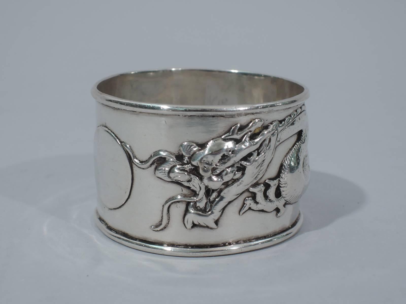 Chinese export silver napkin ring with applied wraparound dragon and circular plate (vacant). Hallmarked with Chinese characters and initials ‘WA’ for unknown maker active at the turn of the century. Condition: Very good with some wear and