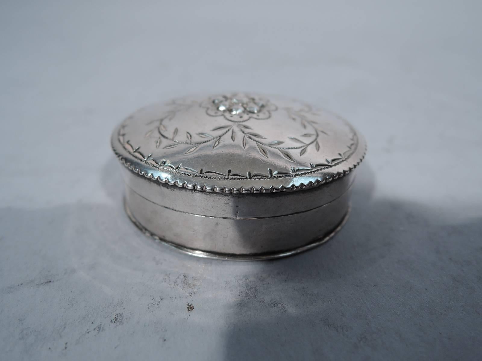 Beautiful German silver box, 18th century. Oval with scalloped rim. Cover has scalloped rim and engraved quatrefoil leaf garland with central low-relief flower. Fully hallmarked on box underside. Excellent condition.

Dimensions: H 3/4 x W 1 3/4 x