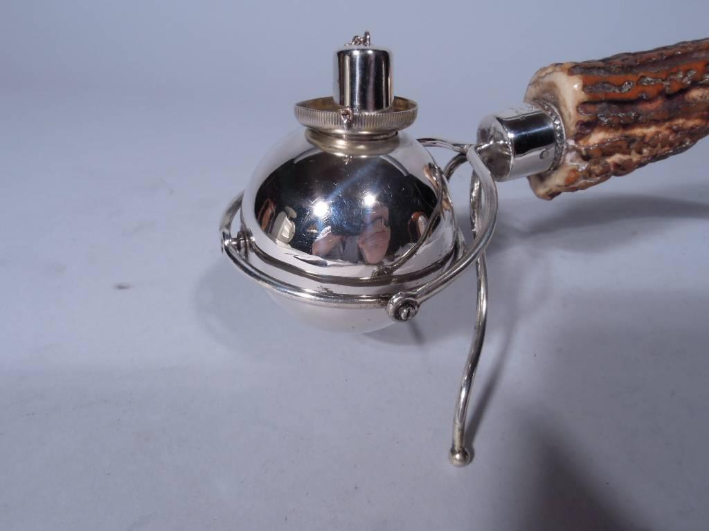Gilded Age sterling silver cigar lighter with antler support. Globular with chained cover and two wire supports. Swing-mounted to antler with silver CAP. Very alpha. For the big game hunter in your life. Worn hallmark – appears to be William W.