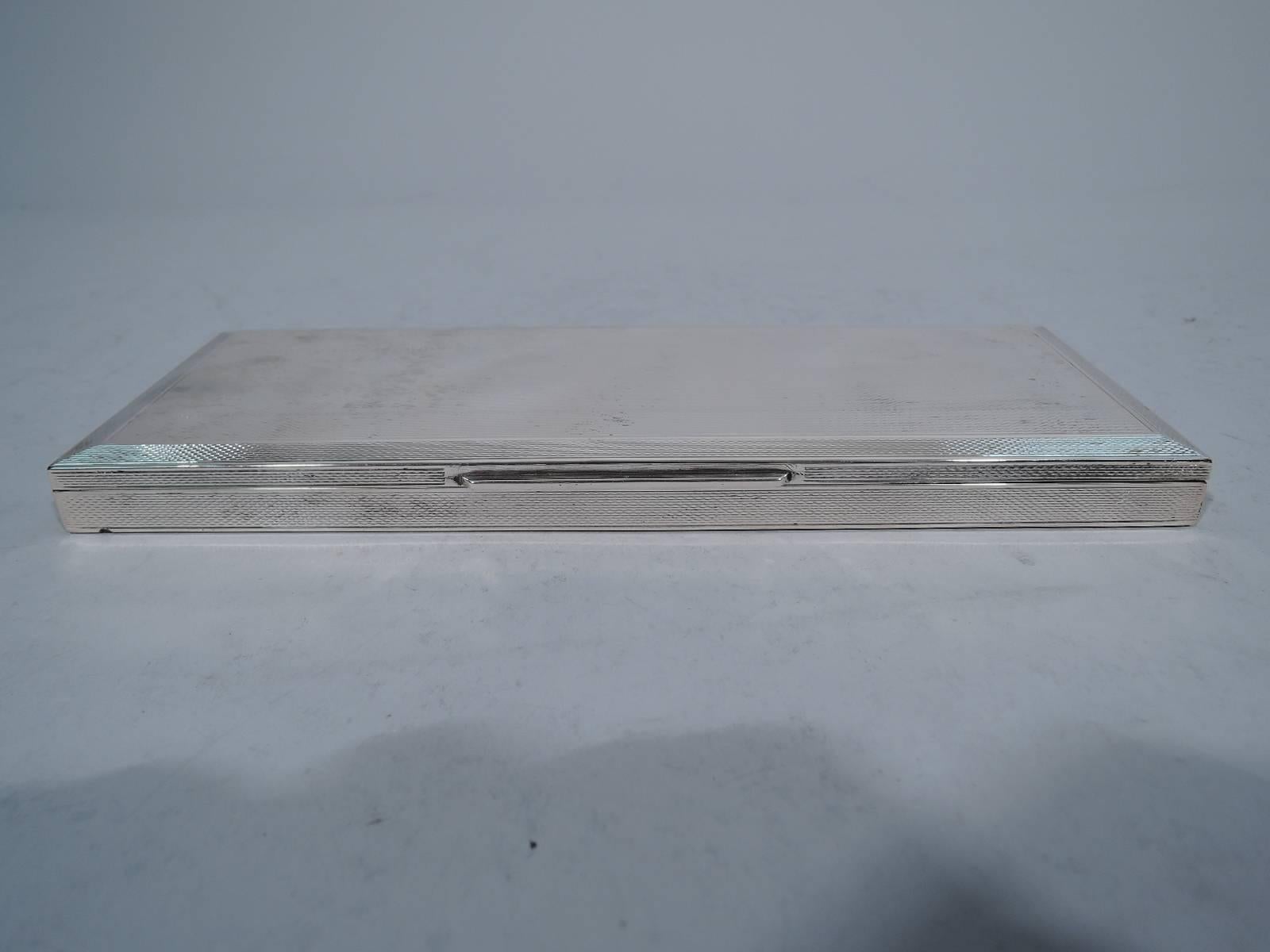 Desk box in 800 silver. Made by Bartolini Bartolozzi in Florence. Rectangular with straight sides. Cover hinged and faceted with straight tab. Engine-turned wave ornament on cover and sides. Underside plain. Snazzy design and unusual form.