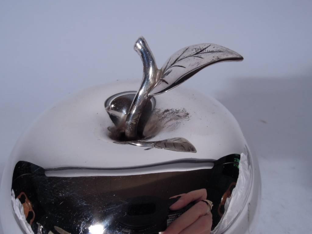 Sterling silver box. Made by Tiffany & Co. in New York. Apple form with leafy stem. A piece of unblemished fruit. Realistic design with a possible regional (that is, New York) association. Hallmark includes postwar pattern no. 23748. Very good form