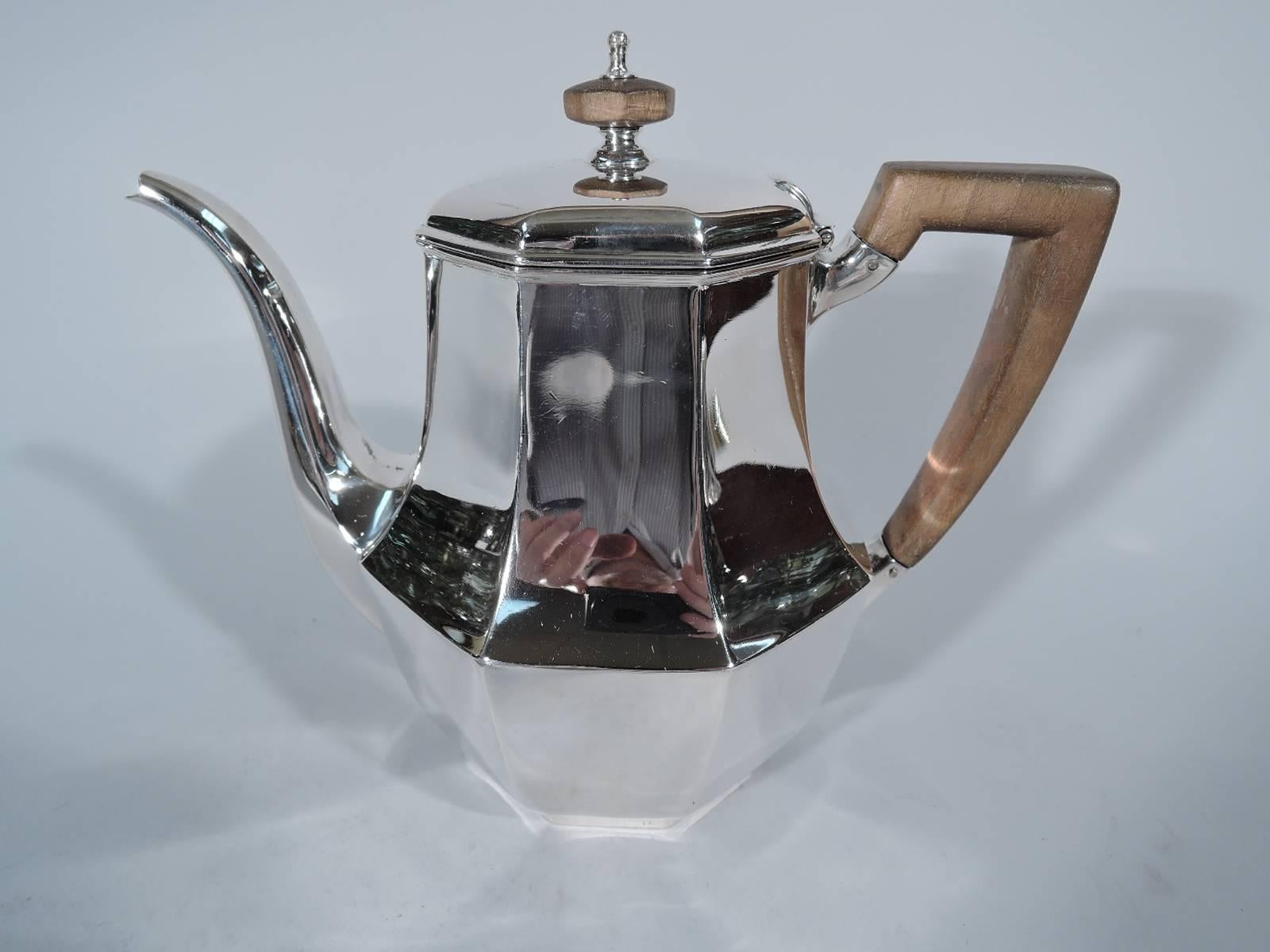 Art Deco sterling silver tea set. Made by Tiffany & Co. in New York, circa 1907. This set comprise teapot, creamer and sugar. All faceted bodies and scrolled bracket handles (teapot handle stained wood.) Teapot has baluster body, raised and