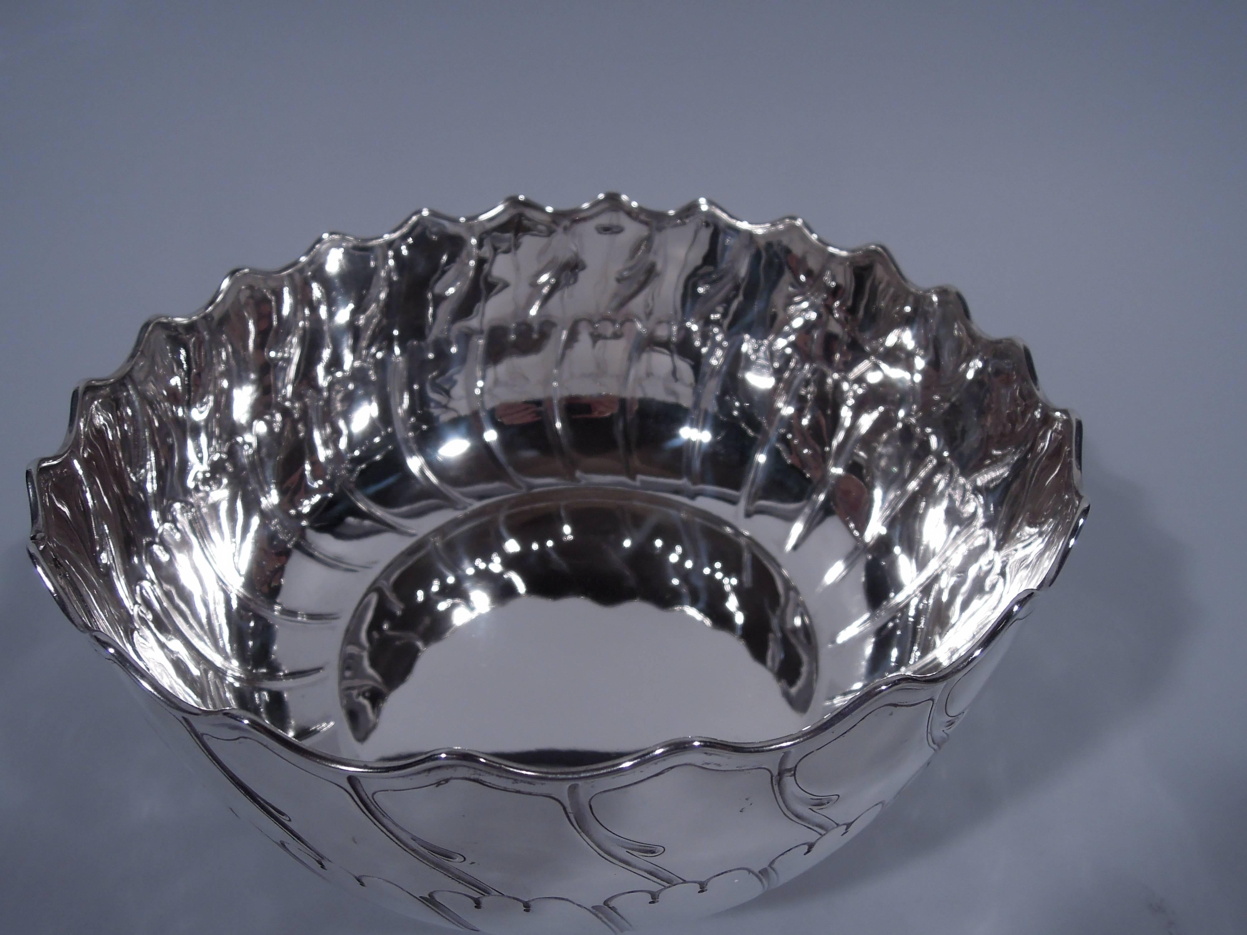 Victorian sterling silver bowl. Made by Edgar Finley and Hugh Taylor in London in 1891. Curved sides, wavy and molded rim, and short foot. Wave ornament incised to sides exterior. A dynamic turn-of-the-century design. Hallmark includes registration
