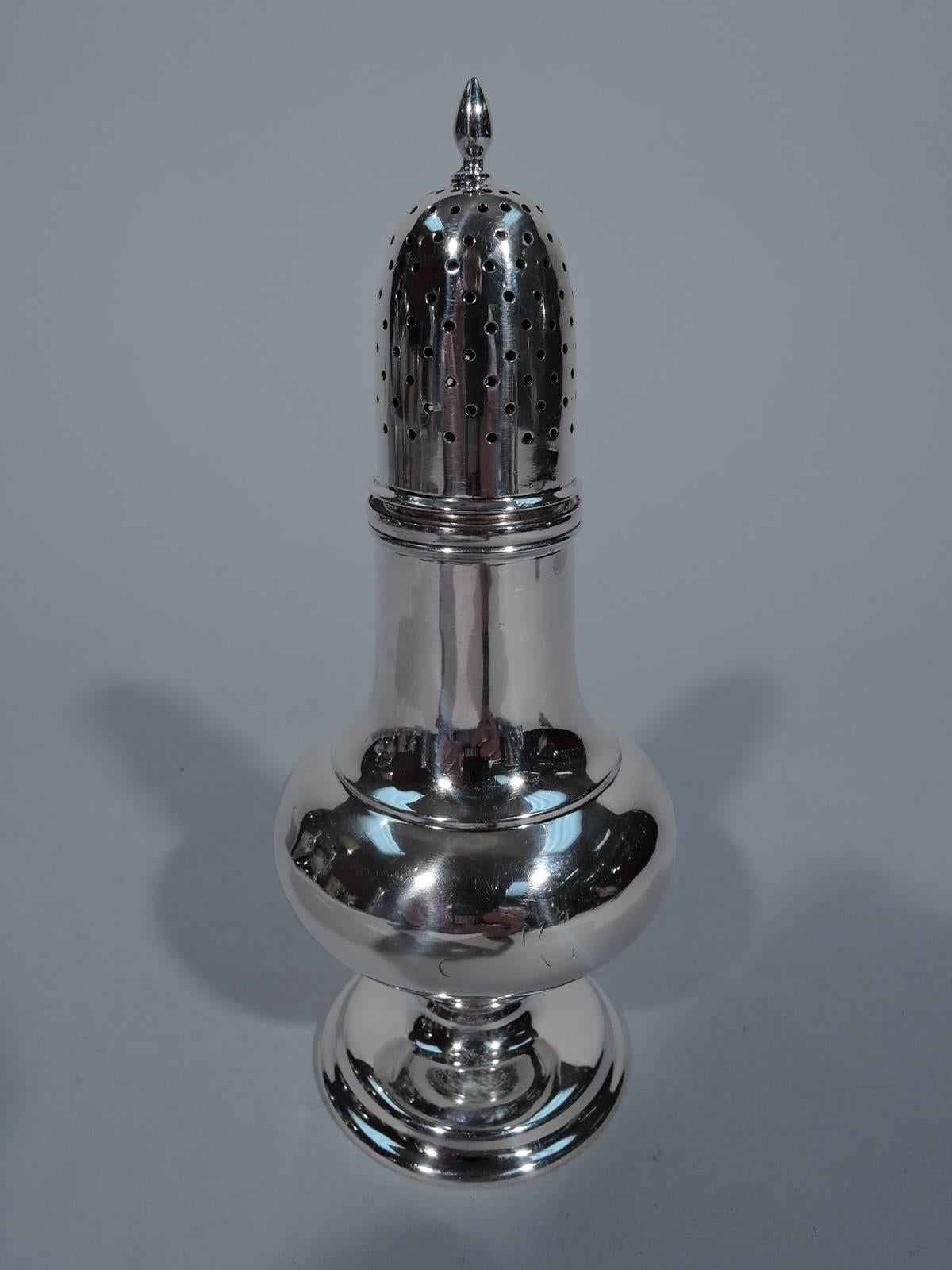 Pair of sterling silver salt and pepper shakers. Made by Tiffany & Co. in New York, circa 1910. Each: bellied baluster on short concave stem mounted to stepped support. Cover pierced and threaded with finial. Hallmark includes no. 2539 and