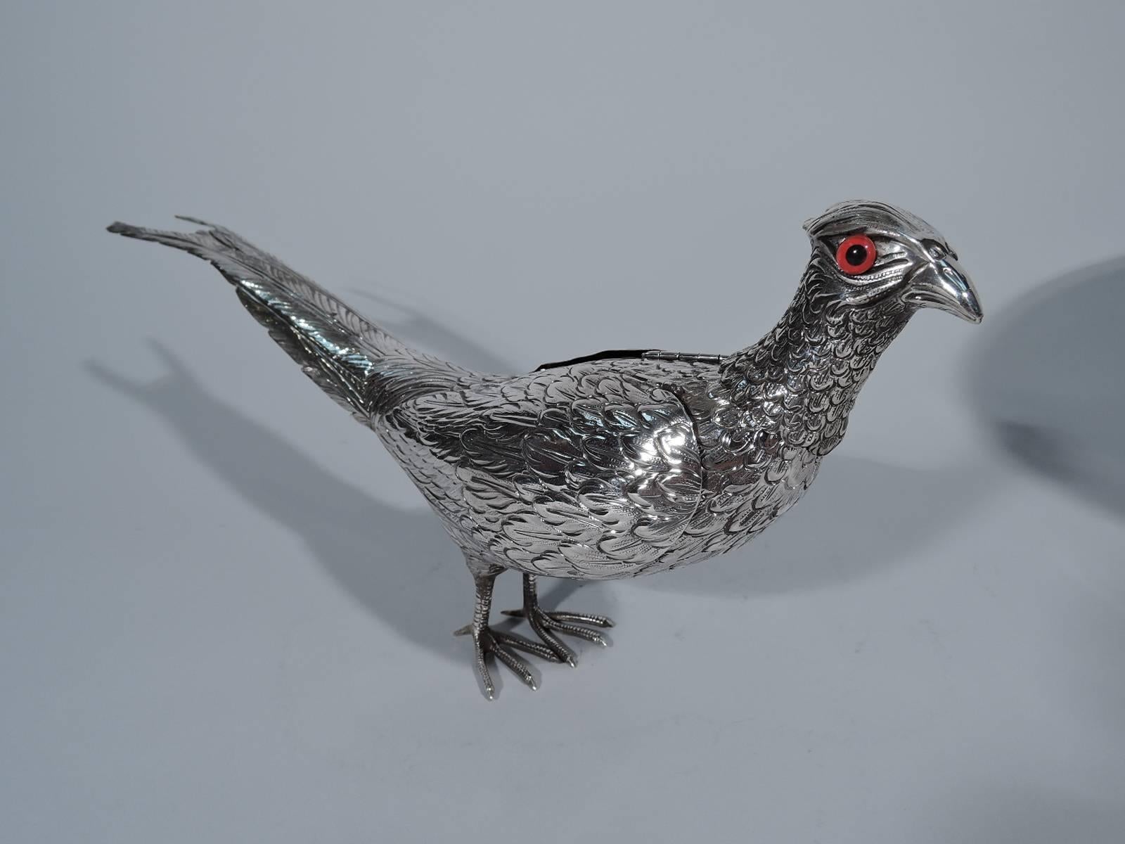 Antique sterling silver pheasant spice box. The bird stands erect with head raised. Well defined plumage and scaly talons. Red glass eyes. Wings hinged. Head detachable. An attractive ornament for a hunt dinner. Hallmarked “sterling.”

Dimensions: