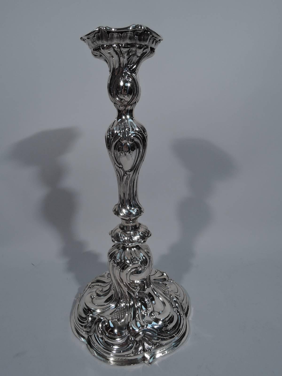 Pair of Rococo 800 silver candlesticks, circa 1900. Made by Strube & Sohn in Germany. Each: Knopped and baluster stem on lobed foot. A dynamic design with scrolls, leaves, and strapwork heightened with pointille. Tall. On foot German script
