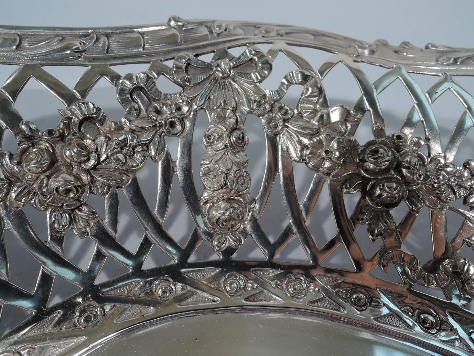 German 800 silver bowl, circa 1900. Solid well with repousse neoclassical group of drapery wearing and vase bearing women. Sides interlaced arcade with four frames (vacant) and floral garland applied to interior. Scrolled rim. Hallmarked. Fine