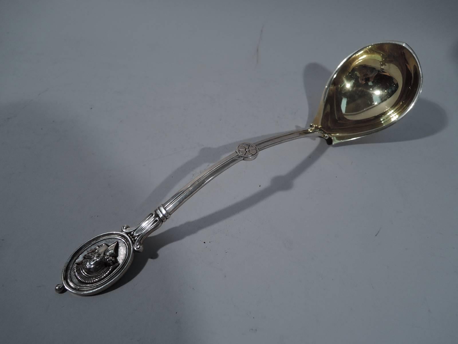 Sterling silver soup ladle in medallion pattern. Made by Bailey & Co. (predecessor to Baily, Banks & Biddle) in Philadelphia, circa 1870. Curved handle terminating in oval medallion applied with Centurion’s head on engraved linear ground. A great