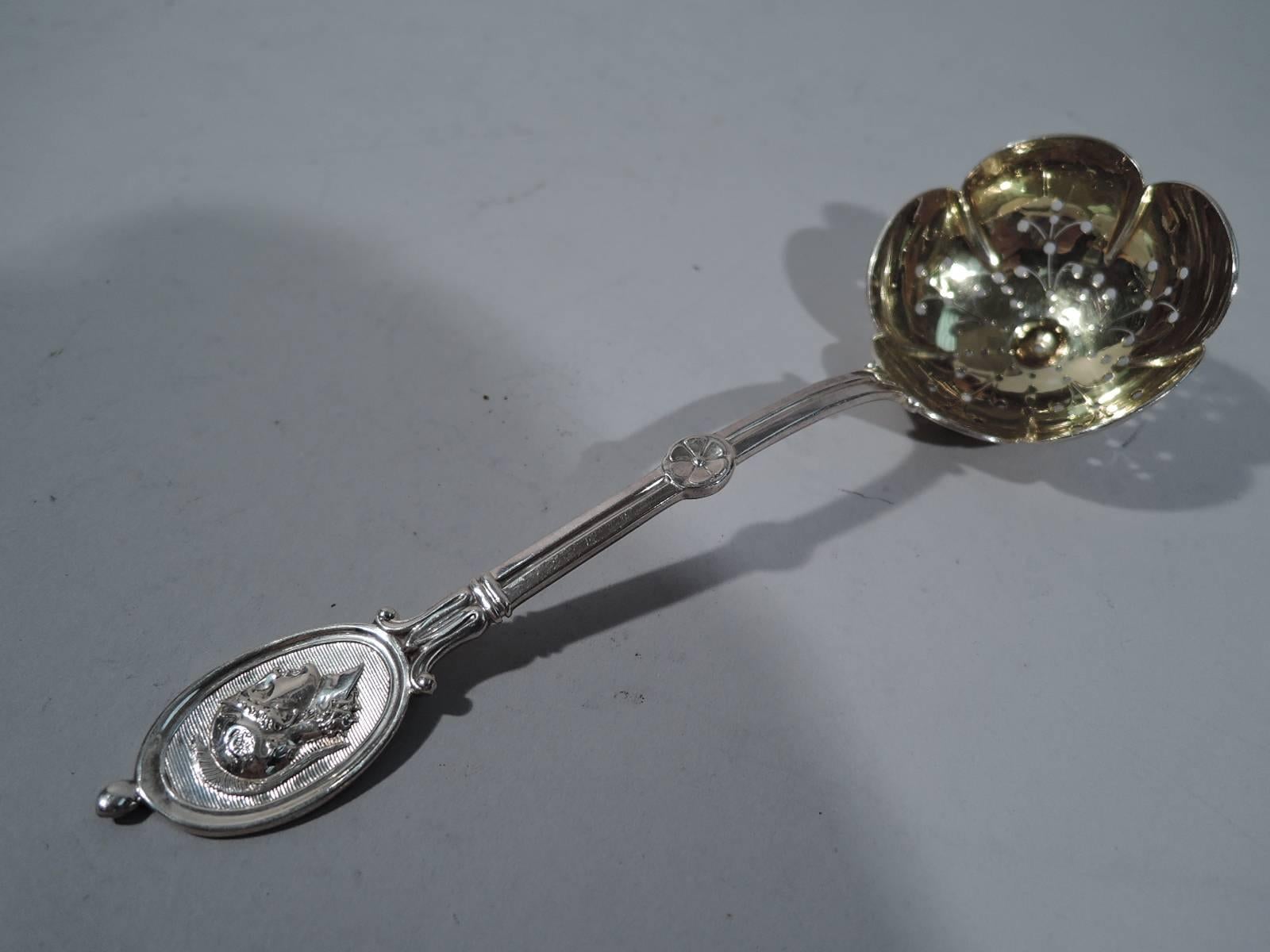 Sterling silver pierced spoon in medallion pattern. Made by JE Caldwell & Co. in Philadelphia, circa 1870. Curved handle terminating in oval medallion applied with Centurion’s head on engraved linear ground. A great piece by a regional maker in the