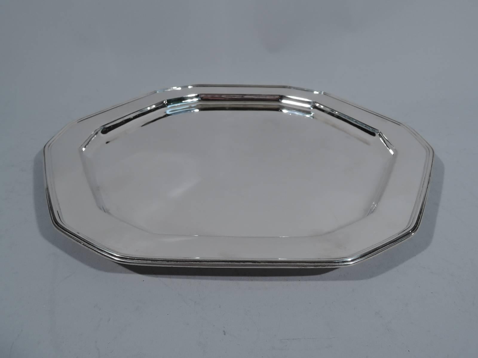 Sterling silver tray. Made by Tiffany & Co. in New York, circa 1917. Chamfered hexagon with well and molded rim. A striking geometric design. Hallmark includes pattern no. 19242 (first produced in 1917) and director’s letter m