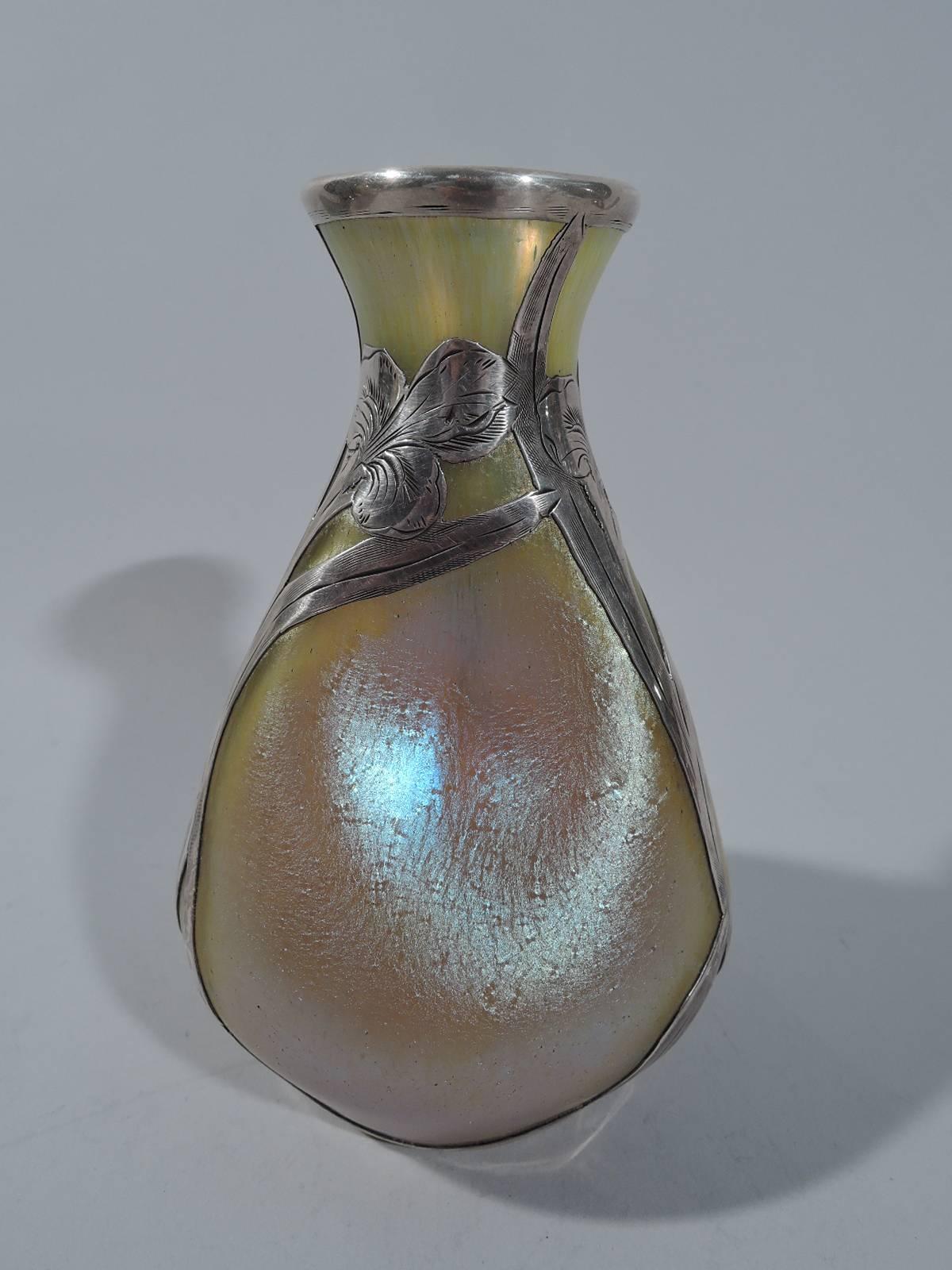 Iridescent gold vase with silver overlay. Made by Alvin in Providence, circa 1900. Pinched and ovoid with overlay frames in form of flowers and leaves. A restrained period design that shows off the rich and shimmering glass. Hallmark includes no.