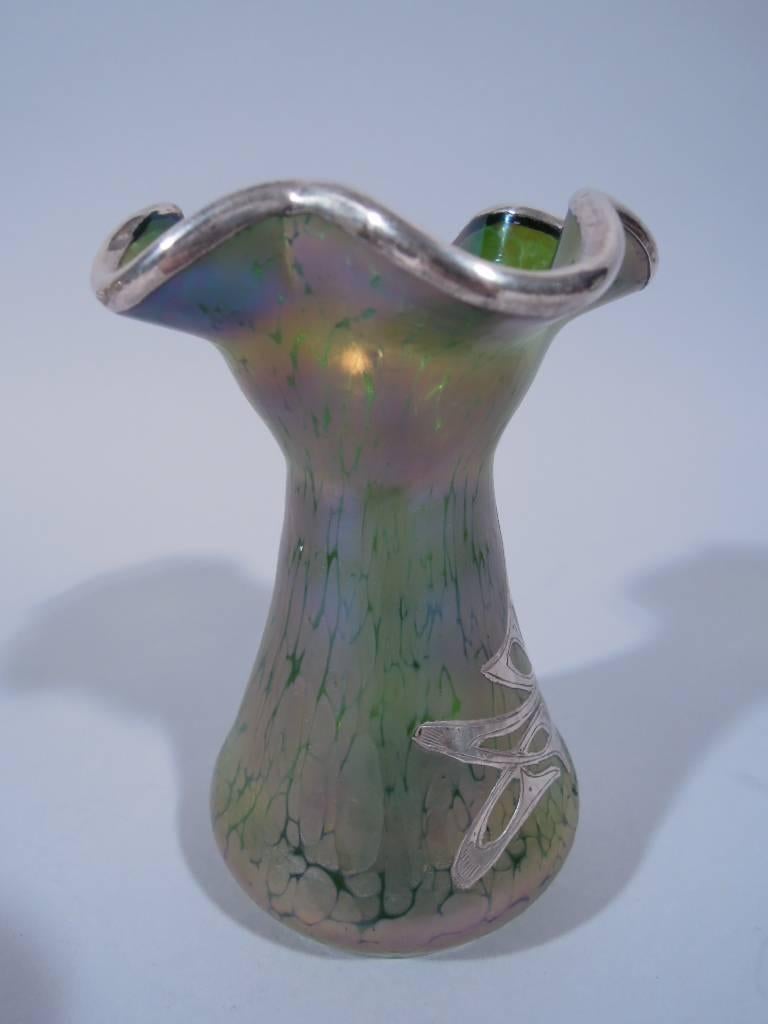 American Art Nouveau iridescent glass vase with silver overlay, circa 1900. Ovoid with ruffled rim. Glass is greenish-purple. Applied to front is symmetrical abstract ornament. A fine turn-of-the-century design.  