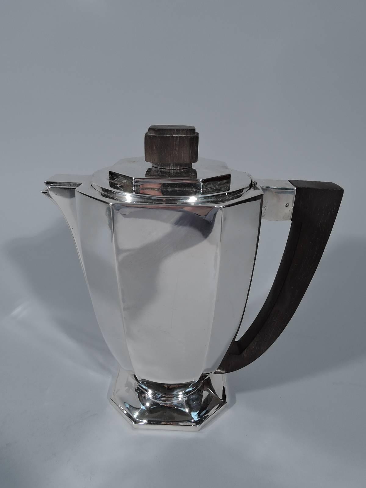 Art Deco 950 silver coffee and tea set, circa 1930. This set comprises coffeepot, teapot, creamer, and sugar. Each: faceted body on faceted foot. All handles ebonized wood as are chamfered block finials. Both pots and sugar have stepped cover with