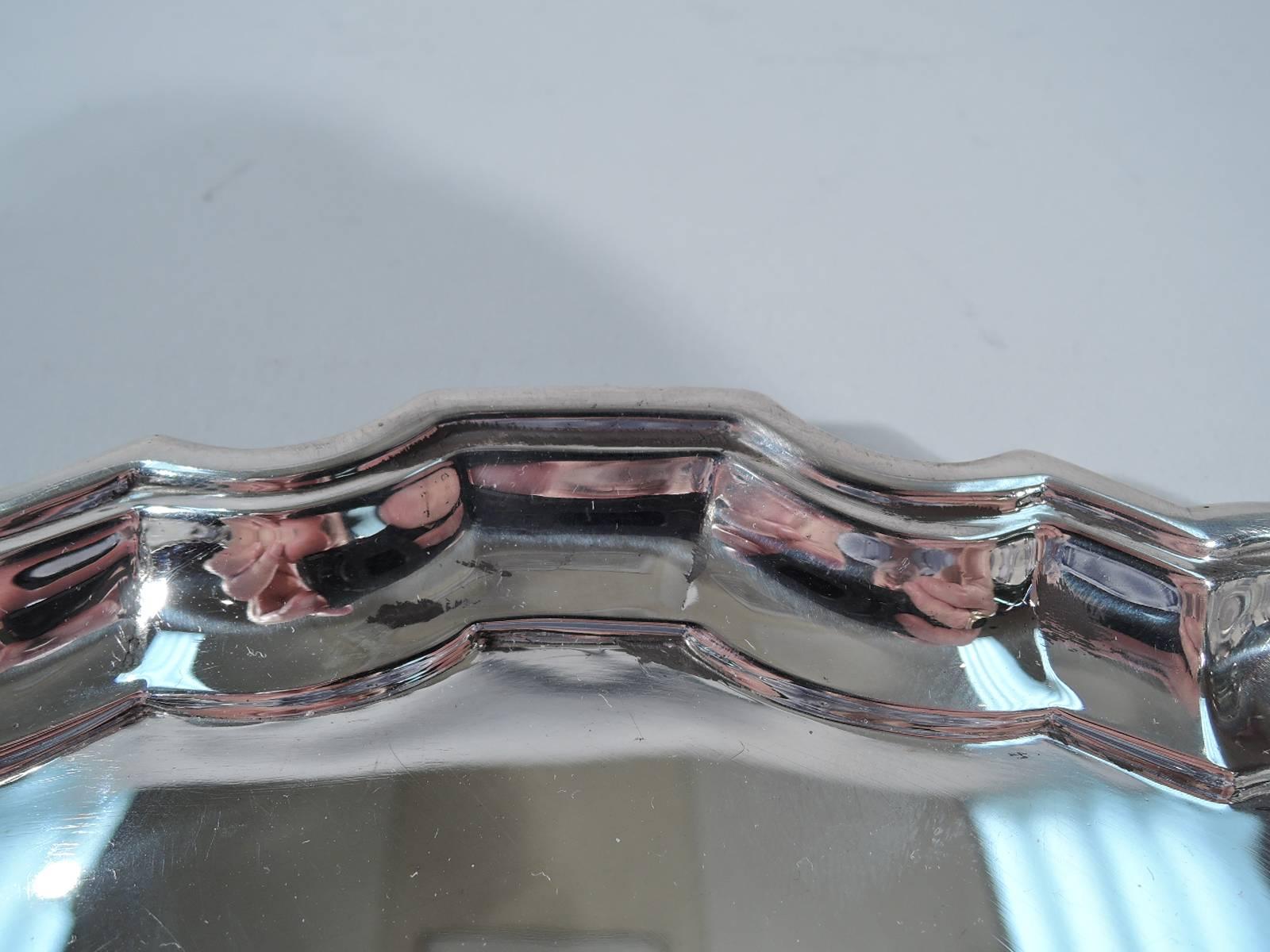 Georgian sterling silver tray. Made by Tiffany & Co. in New York. Circular with molded curvilinear piecrust rim. Hallmark includes pattern no. 21744 and director’s letter M (1947-1956).

Dimensions: H 3/8 W 14 x D 14 in. Heavy weight: 43 troy