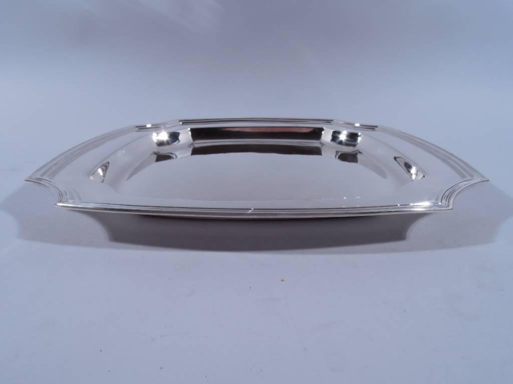 Sterling silver tray. Made by Tiffany & Co. in New York, circa 1921. Four curved sides with reeded rim, concave corners, and deep well. An unusual but practical design, a great addition to the buffet. Hallmark includes no. 19915 (first produced in