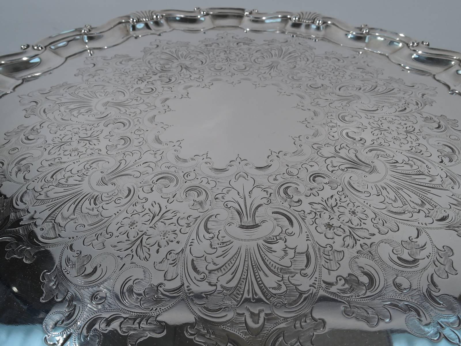 Edwardian sterling silver salver. Made by Marples & Co. (a subsidiary of Martin, Hall) in Sheffield in 1904. Molded rim has alternating ‘C’ and ‘S’ scrolls interspersed with scallop shells. Central scalloped frame (vacant) surrounded by engraved
