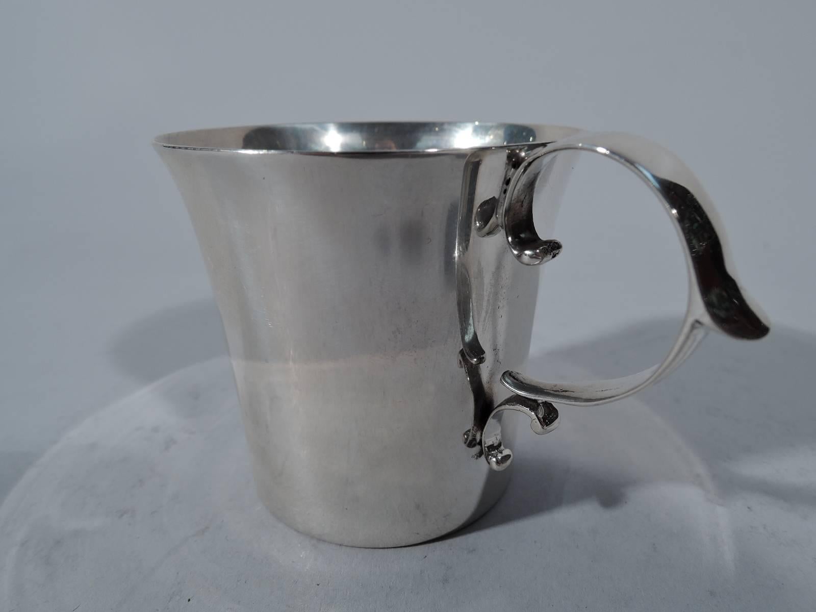 Neat and elegant sterling silver baby cup. Made by Gorham in Providence in 1919. Flared rim and capped double-scroll handle. Lots of room for engraving. Hallmark includes date symbol and no. 3284A. Fine condition.

Diminutive dimensions: H 2 1/4 x