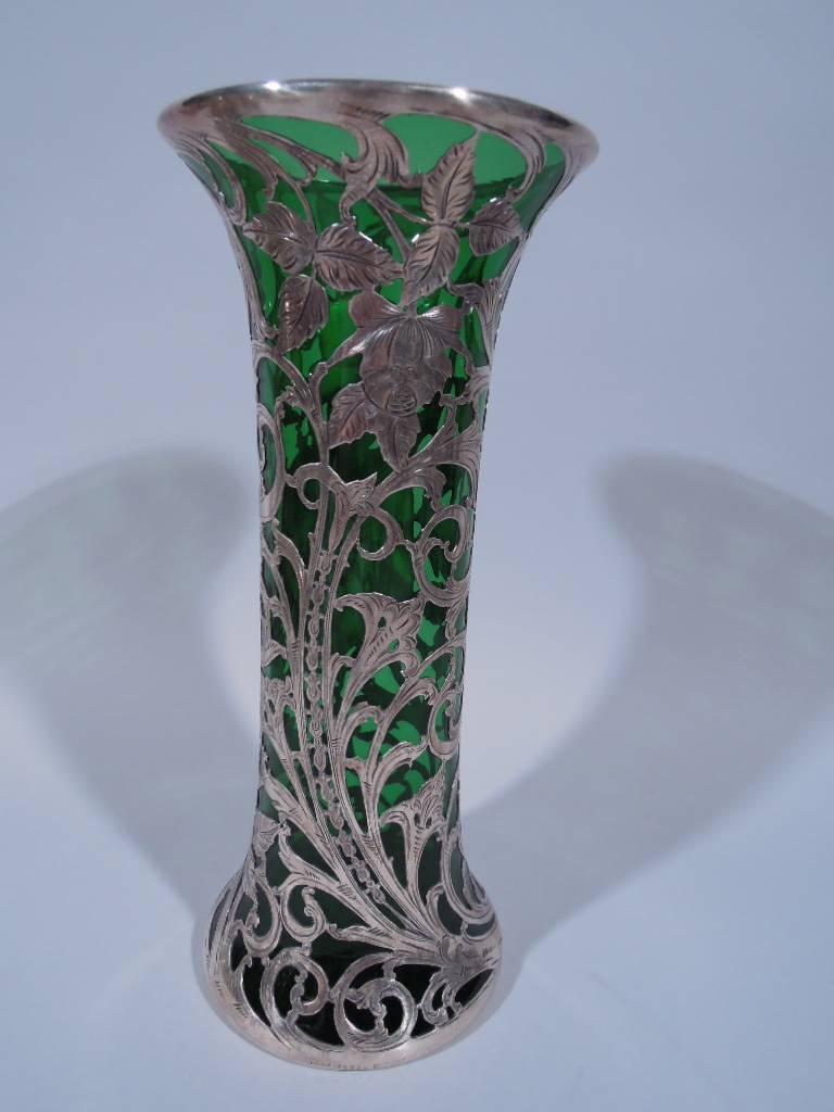 Art Nouveau emerald glass vase with silver overlay. Made by Alvin in Providence, circa 1900. Cylindrical with spread base and flared mouth. Dense overlay heightened with engraving in form of flowers and scrolls. Scrolled cartouche has engraved