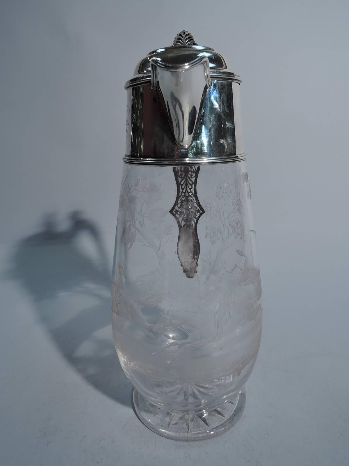 Victorian sterling silver and glass decanter. Made by Elizabeth Hutton in London in 1883. Clear glass upward tapering sides and circular foot. Acid-etched hunting scene with crop-wielding rider spurring on his galloping companions. Neck has silver