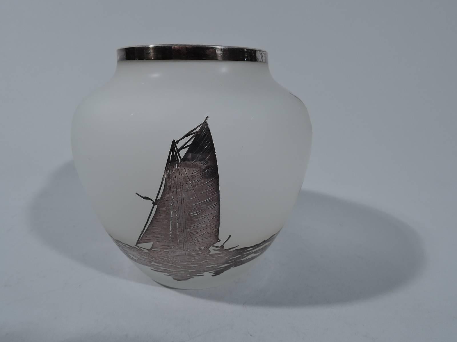 Antique camphor glass baluster vase with pictorial silver overlay. Glass is white and overlaid with seascape: wraparound waves with hovering seagulls and solitary sailboat. Unmarked. Very good condition.

Dimensions: H 4 3/4 x D 4 1/2 in. BM689.