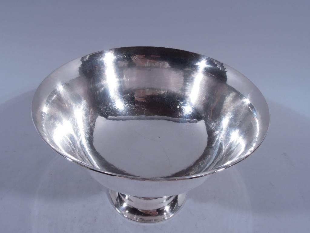 Sterling silver footed bowl. Made by Georg Jensen in Copenhagen. Round bowl with flared rim mounted to open support with alternating grape bunches and stems terminating in bead. Rests on solid domed foot. All-over visible hand hammering. Postwar