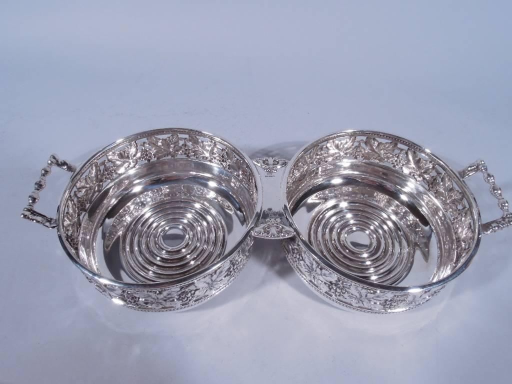 Sterling silver double coasters. Made by Buccellati in Italy. Two joined circular coasters, each with pierced fruiting grapevine between beaded borders, and single end bracket handle, Italian hallmark (1968 to present). Very good