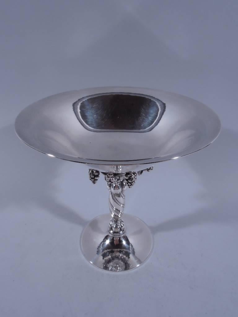 Beautiful sterling silver grape compote. Made by Georg Jensen in Copenhagen. Bowl has curved sides and flared rim. Applied to base exterior is fruiting grapevine with pendant bunches. Twisted support with lobes and beads. Raised circular foot. A